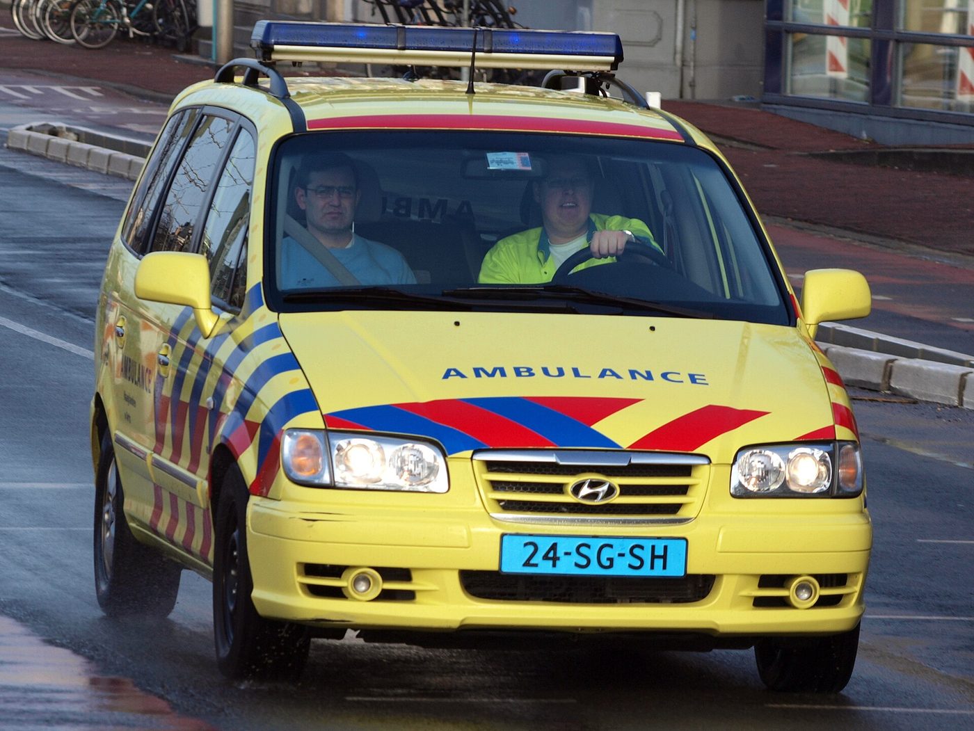 An ambulance responding on a Dutch street